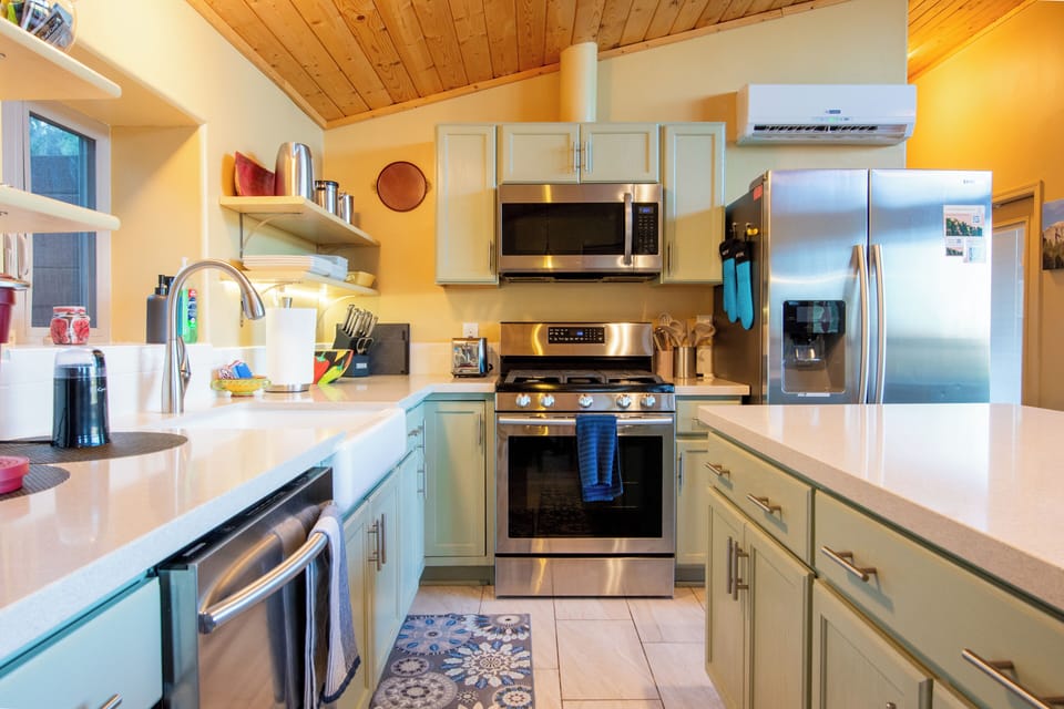 Fully stocked kitchen with gas range, oven, and dishwasher