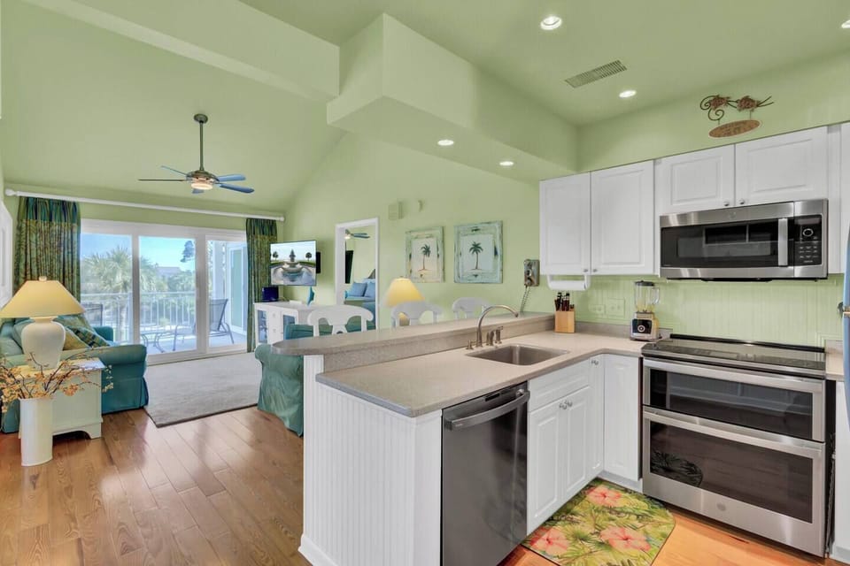 Bright and open, the living room, dining room, and kitchen flow together seamlessly, creating the perfect space for meals and gatherings. Ideal for beachside relaxation, this inviting layout brings everyone together for memorable moments.