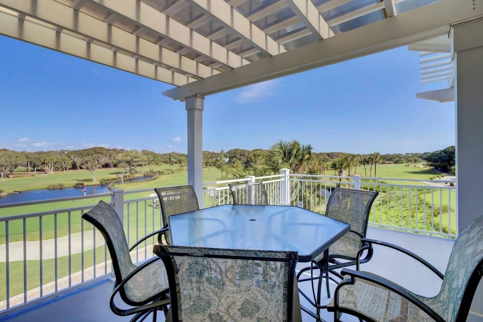 Relax on your private corner deck with serene views of the lush golf course and 18th hole, perfect for watching golfers finish their game. Bring binoculars to spot local birds and the occasional alligator, enhancing the natural beauty.