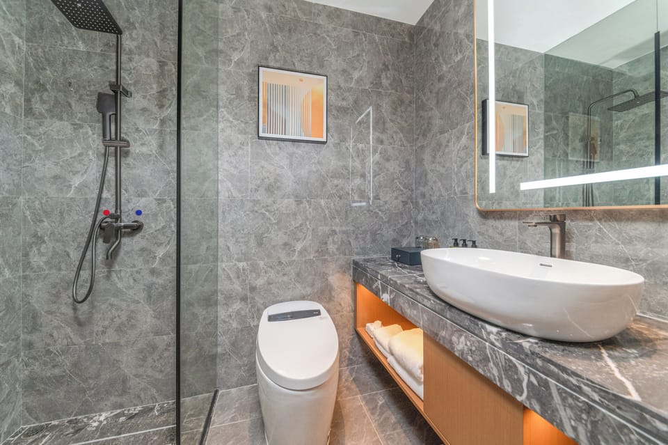 Shower, rainfall showerhead, slippers, towels