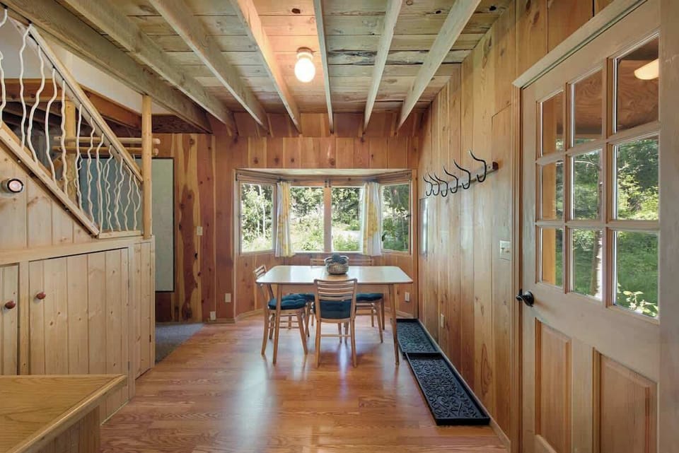 Entry with dining table, washer-dryer under stairs, Nest thermostat.