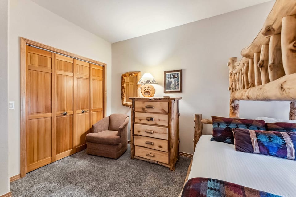 Bedroom 2: Twin-over-queen bunk bed, dresser, sofa chair, large closet
