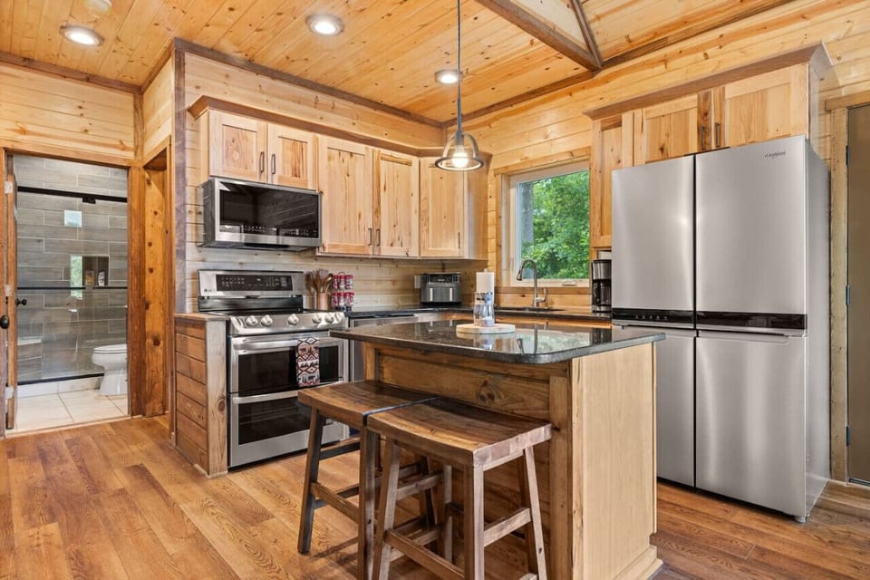 Cook up a storm in our fully equipped kitchen featuring a double oven, air fryer, kitchen island with bar seating, and all the essentials for your culinary adventures.