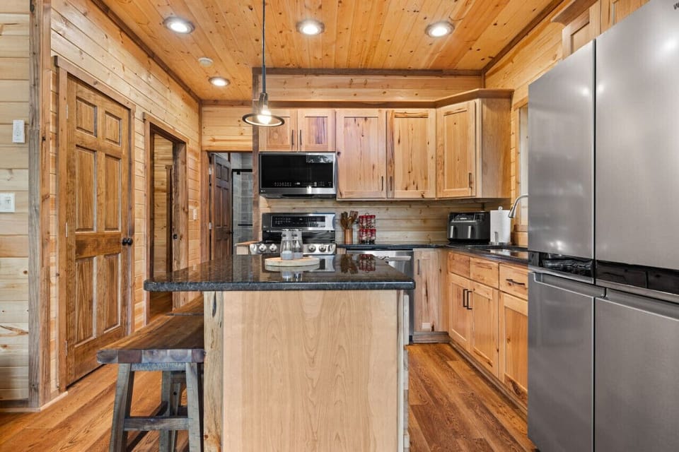 Cook up a storm in our fully equipped kitchen featuring a double oven, air fryer, kitchen island with bar seating, and all the essentials for your culinary adventures.