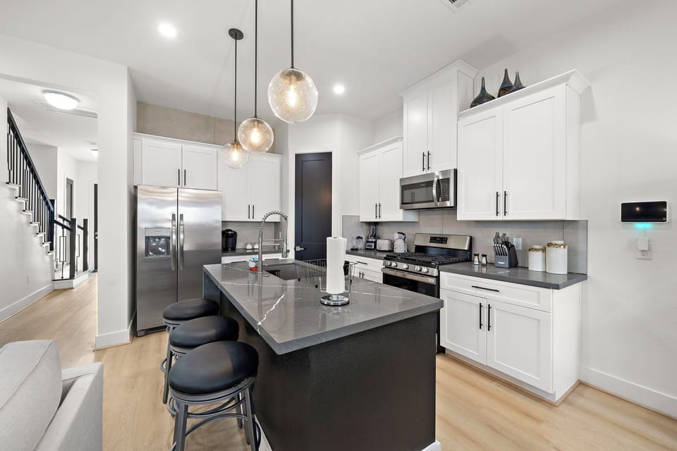 Fridge dispenses water and ice. Stainless steel appliances.