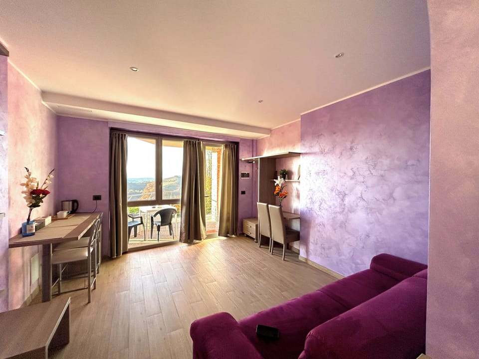 Comfort Quadruple Room, Hill View | Living area | TV