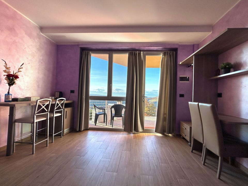 Comfort Quadruple Room, Hill View | Living area | TV