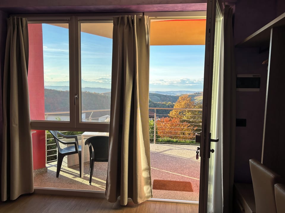 Comfort Quadruple Room, Hill View | Living area | TV