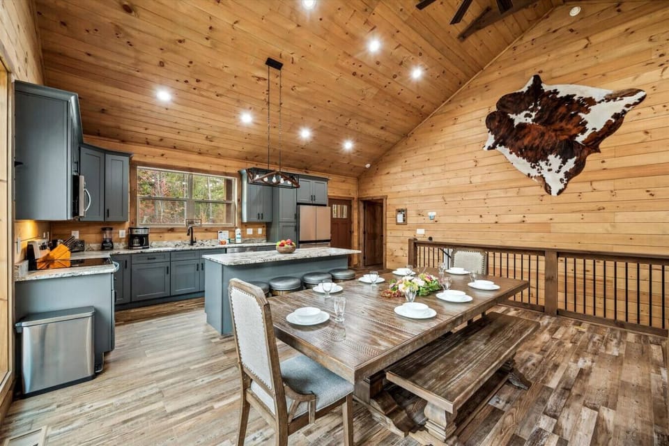 The beautiful wood dining table is located just off the kitchen and has plenty of seating for 8 guests.