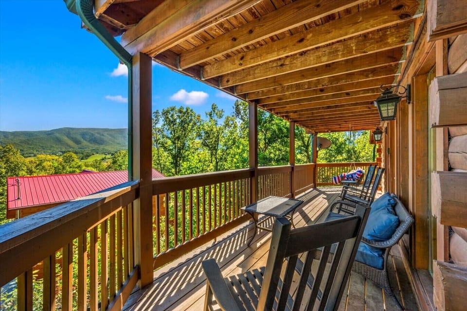 The wraparound deck includes plenty of seating, a porch swing and beautiful mountain views.