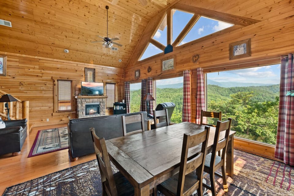 Dine with the mountains as your backdrop. This open-concept living space features a cozy fireplace, rustic wood charm, and huge picture windows that frame the Smokies in every season.