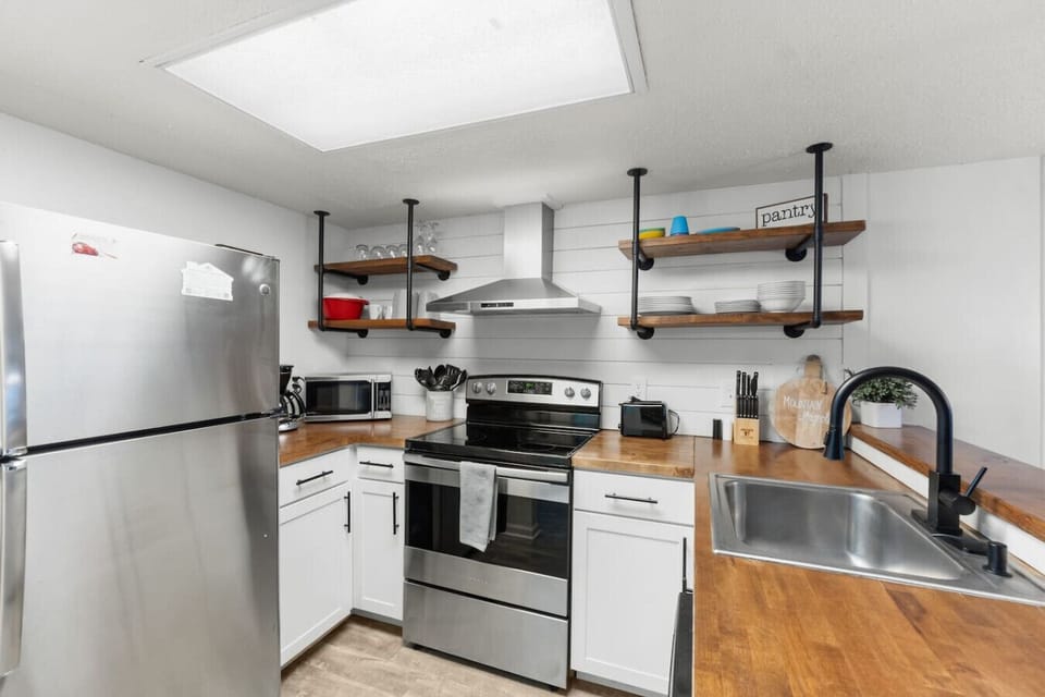 The kitchen includes a full suite of appliances as well as cookware, bakeware, silverware, and more. It includes a Keurig and traditional coffee maker.