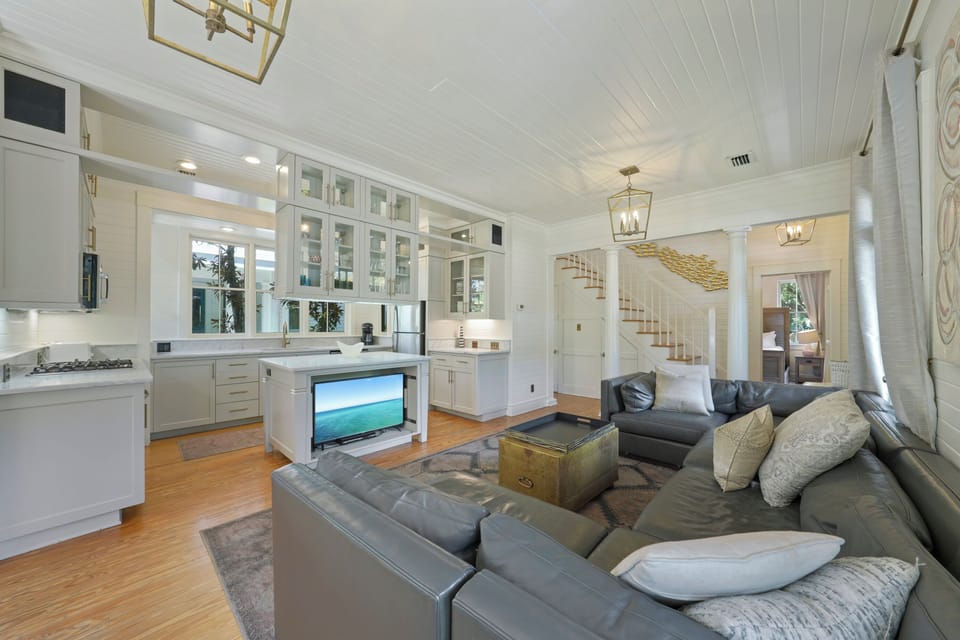 OPEN KITCHEN AND LIVING - SECTIONAL & FLAT SCREEN TV IN CENTER C