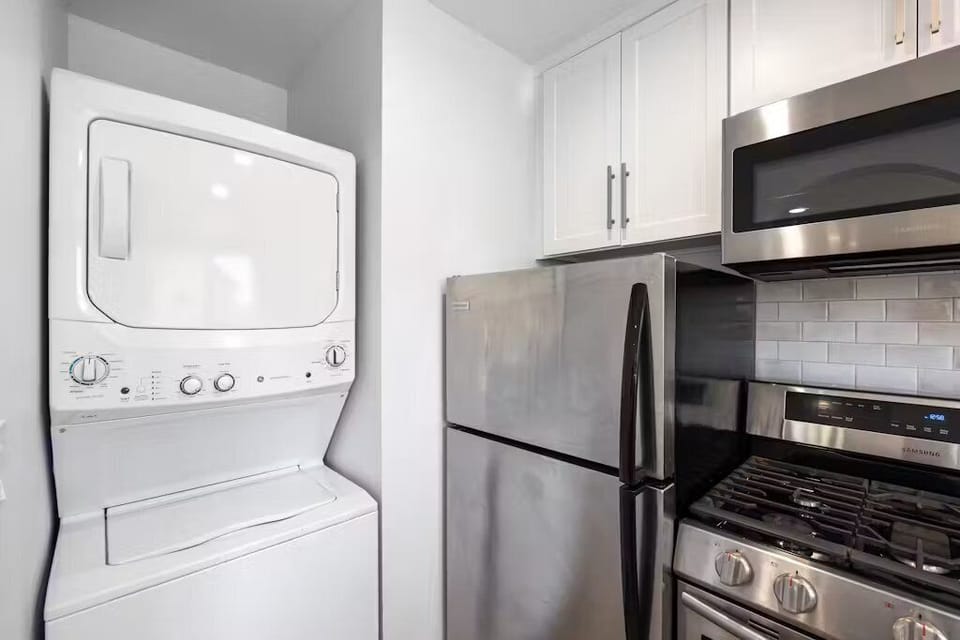 Stacked washer and dryer is located in the kitchen alcove.