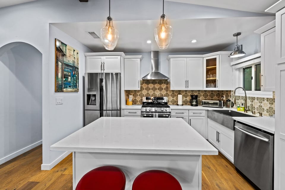 Cook in style with this sleek modern kitchen featuring top-of-the-line stainless steel appliances.