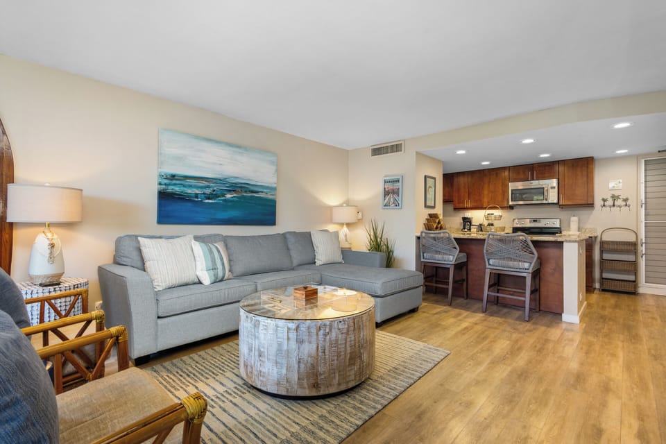 Step into your bright, coastal-inspired retreat with plush seating, a stylish living area, and a fully equipped kitchen—perfect for relaxing after a day of adventure.