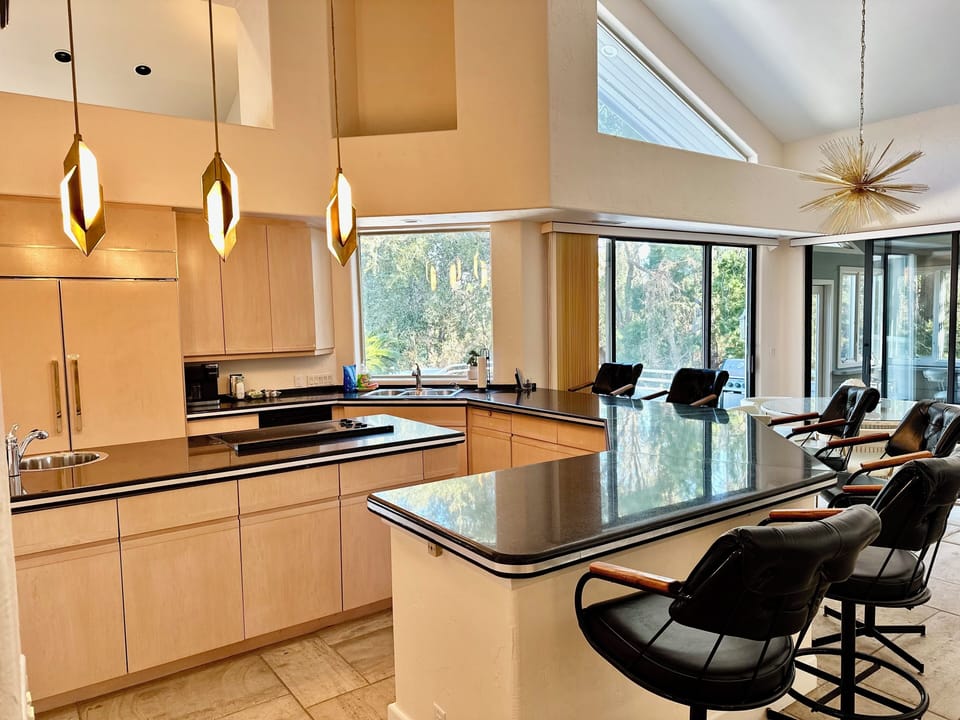 Kitchen with counter seating for 6. SubZero fridge, stove top, double oven