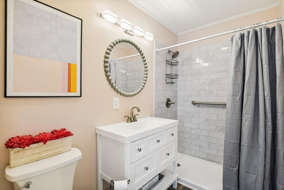 Step into your private bathroom, where crisp white subway tile and soft lighting create a calm, refreshing retreat. Fresh towels and thoughtful touches welcome you after a long day of exploring.
