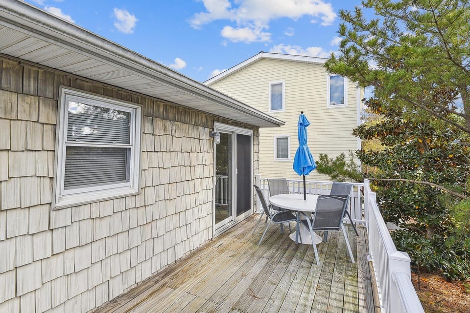 The property features a spacious outdoor deck—perfect for morning coffee or evening meals under the open sky, surrounded by lush greenery.