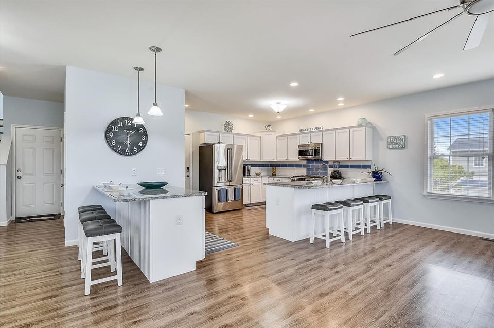 Picture yourself gathering around this spacious kitchen island with granite countertops, where meals become memories. Modern appliances and bright, coastal-inspired touches await your culinary adventures.