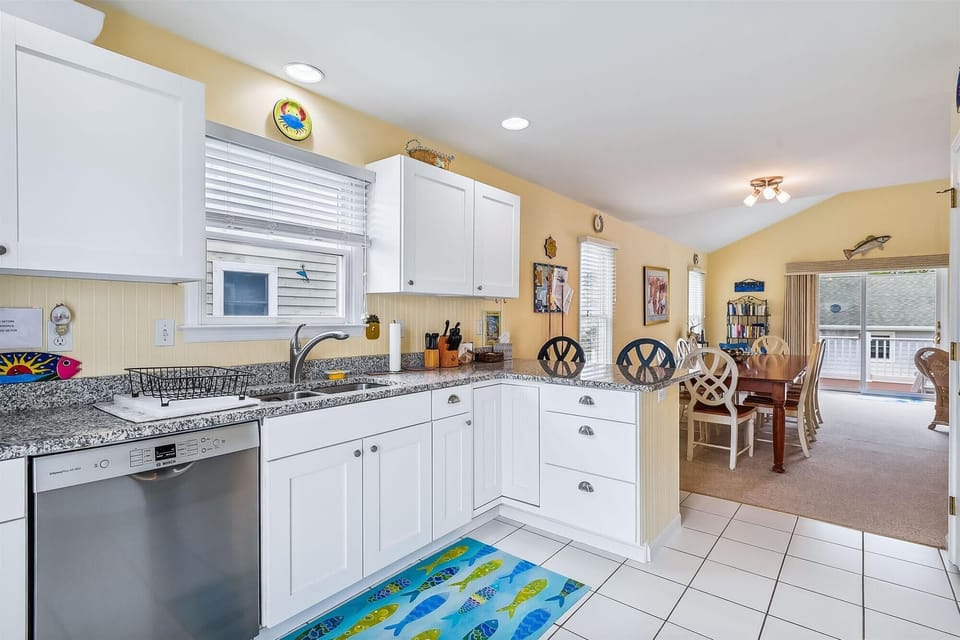 Step into your bright, fully-equipped kitchen with granite countertops and ample storage. The cheerful coastal-themed touches and open layout make meal prep a pleasure—just steps from the dining area.