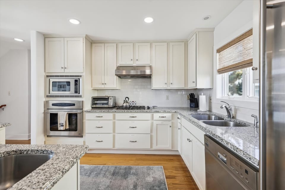 Step into your gleaming chef's kitchen with sleek granite counters, stainless appliances, and crisp white cabinetry—everything you need to whip up meals and make memories.
