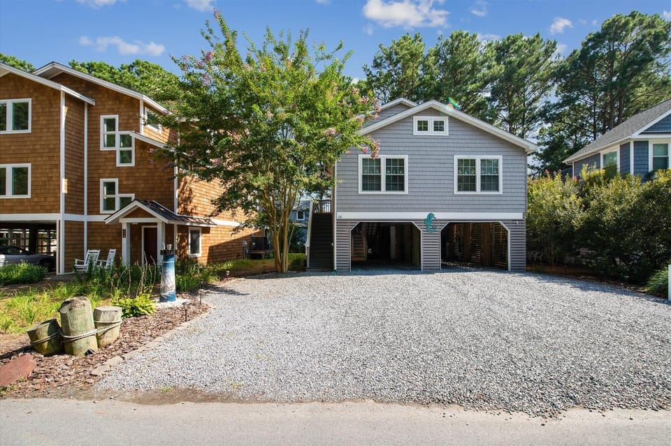 Charming coastal home with spacious gravel parking, nestled in a quiet, tree-lined neighborhood—your perfect retreat awaits.