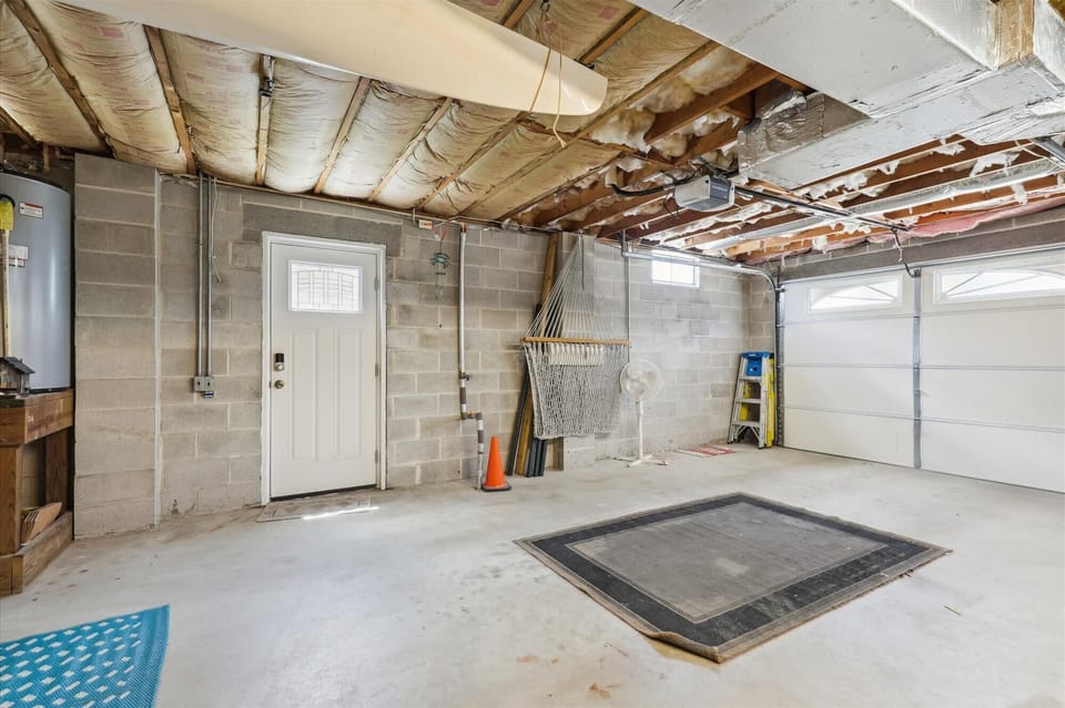 Spacious garage with exposed beam ceiling and direct interior access for your convenience.