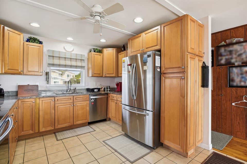 Your fully equipped kitchen features warm wood cabinetry, stainless steel appliances, and plenty of counter space for preparing meals together during your stay.