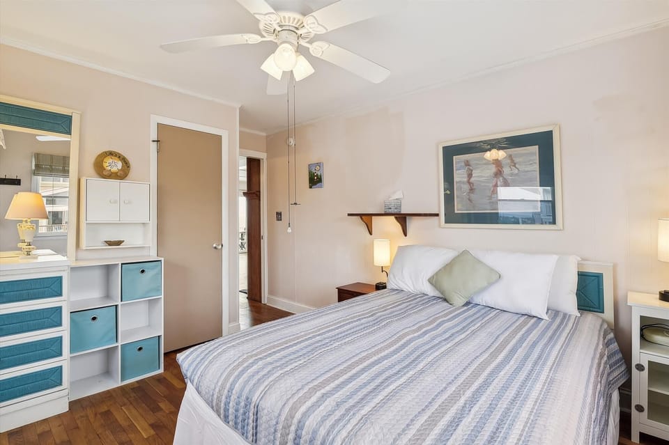 Drift into restful sleep under your own ceiling fan, surrounded by beach-inspired coastal decor that brings the tranquility of the shore right to your bedside.