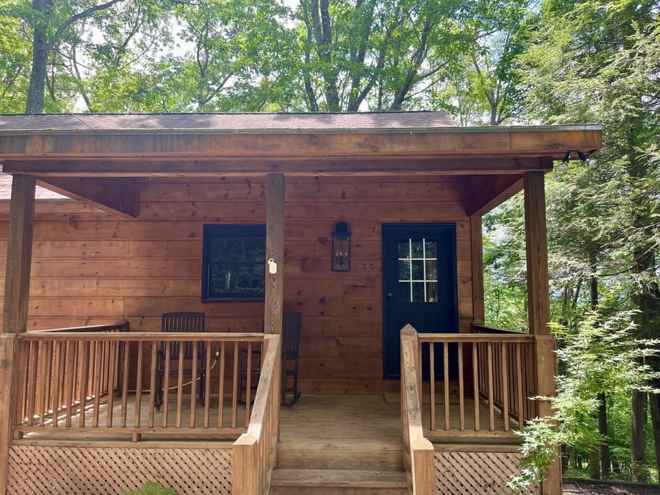 Front entrance with covered porch and rocking chairs.