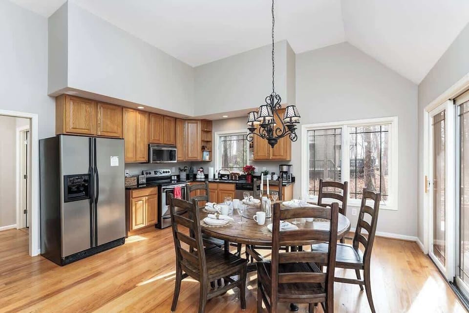 Open kitchen with round dining table .