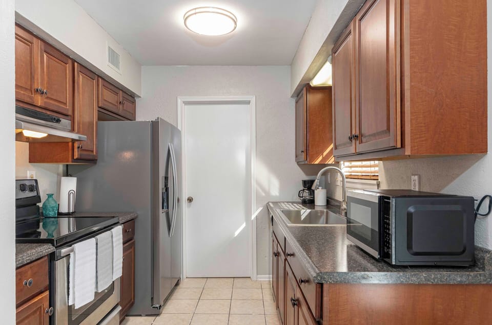 Cook up a feast in our cozy kitchen, featuring modern appliances.