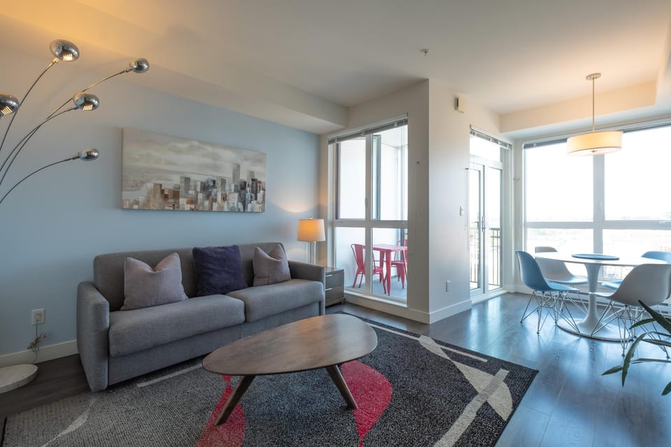 Open living space showcasing direct sightlines connecting the seating lounge and the adjoining dining area.