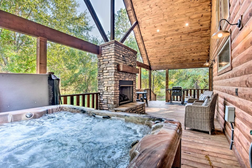 Outdoor Oasis: Unwind in the hot tub with scenic views and a cozy stone fireplace!