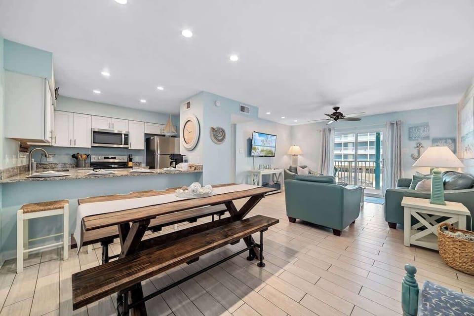 Spacious dining area with adequate seating for 6-8 comfortably. Living Room: Bright space with beachy decor, a comfy layout, and views that invite relaxation!
