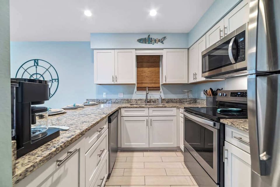 Captains kitchen - fully stocked with everything needed during your stay.  Bright and stylish space perfect for culinary adventures at the beach! Dive in!
