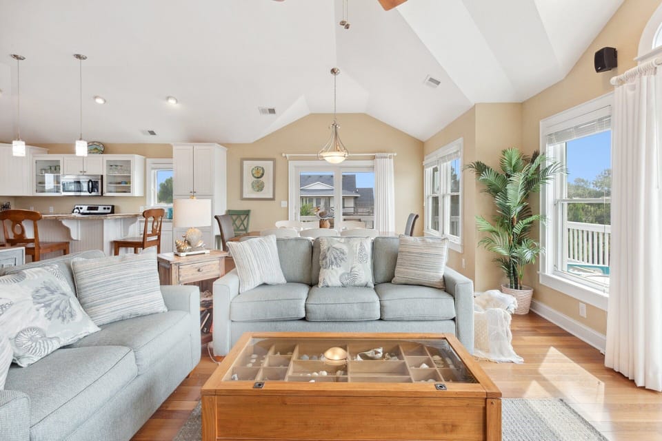Your family will adore the Top-Level Living Area with bright cathedral ceilings, hardwood floors, and bountiful natural lighting coming in through the walls of windows.