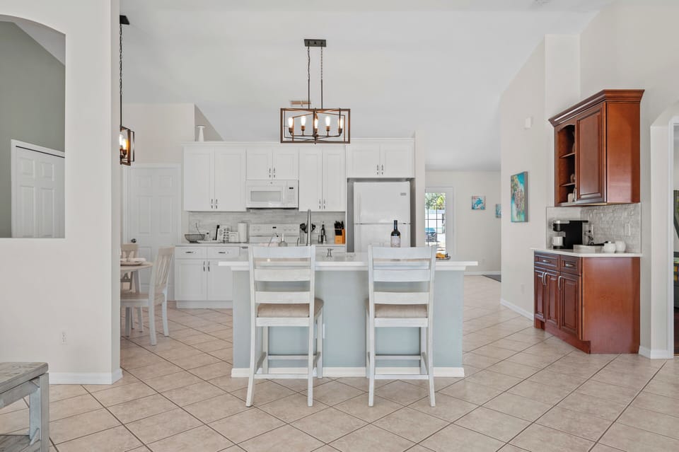 The open-air kitchen is perfect for hosting! Relax at the kitchen island.