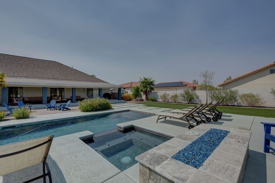 Pool, spa and firepit in backyard