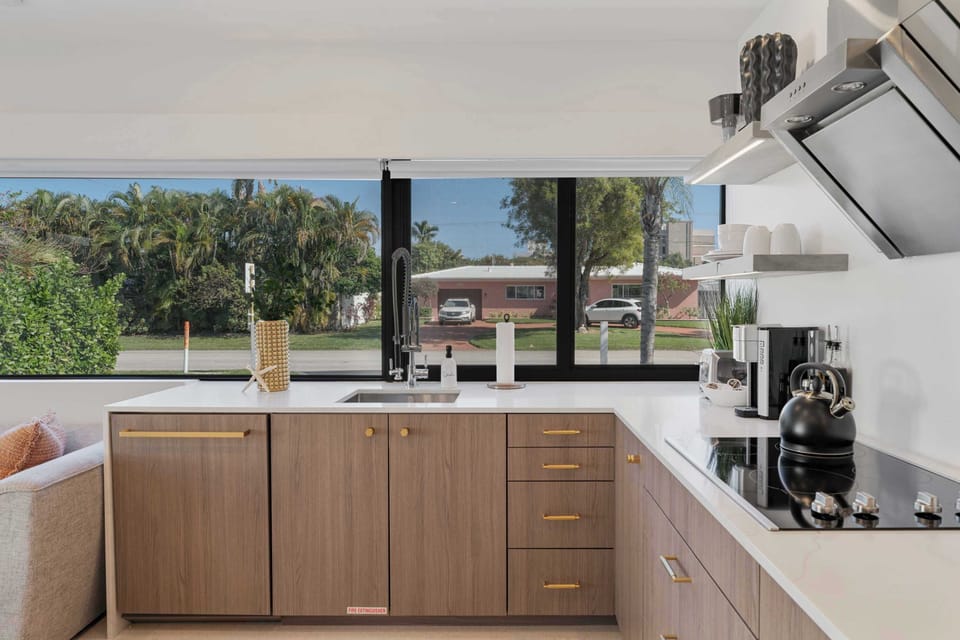 Enjoy cooking in a kitchen with expansive windows, where natural light pours in and provides a picturesque view to brighten your day.