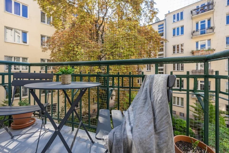  A balcony overlooking trees and a green courtyard is the perfect spot for morning coffee.