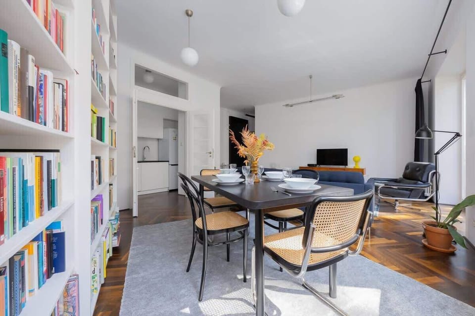  A bright and spacious living room with a library and comfy seating is the heart of the apartment.