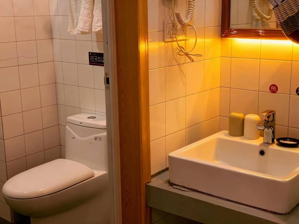 Shower, hair dryer, slippers, towels