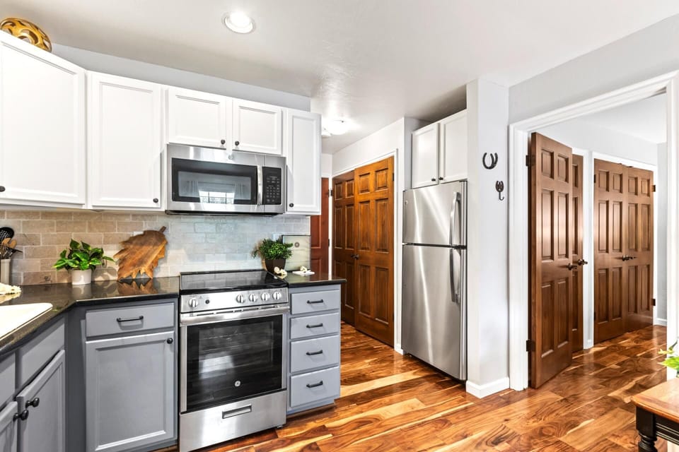 Granite countertops and stainless appliances bring modern convenience to this compact kitchen.