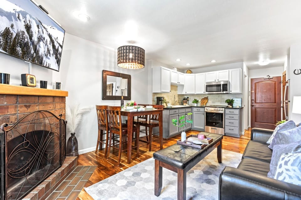 Warm wood tones and a fireplace create a welcoming setting for shared meals or game nights.