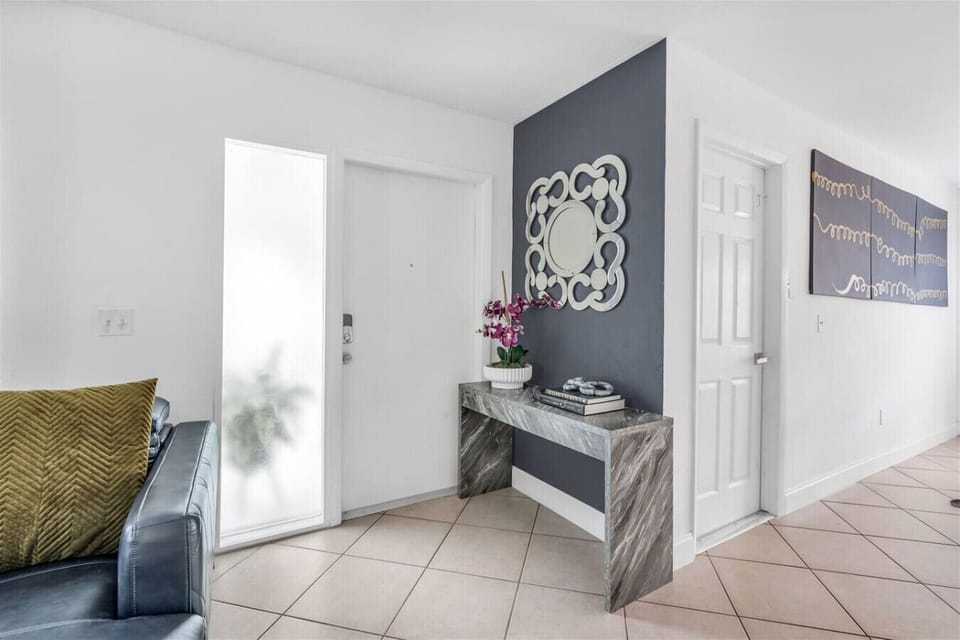 Foyer: Elegant entryway with stylish decor and vibrant touches to welcome you!