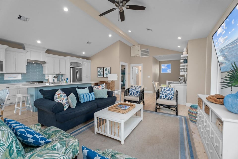 Open living and kitchen layout with vaulted ceilings, perfect for entertaining and family vacations.