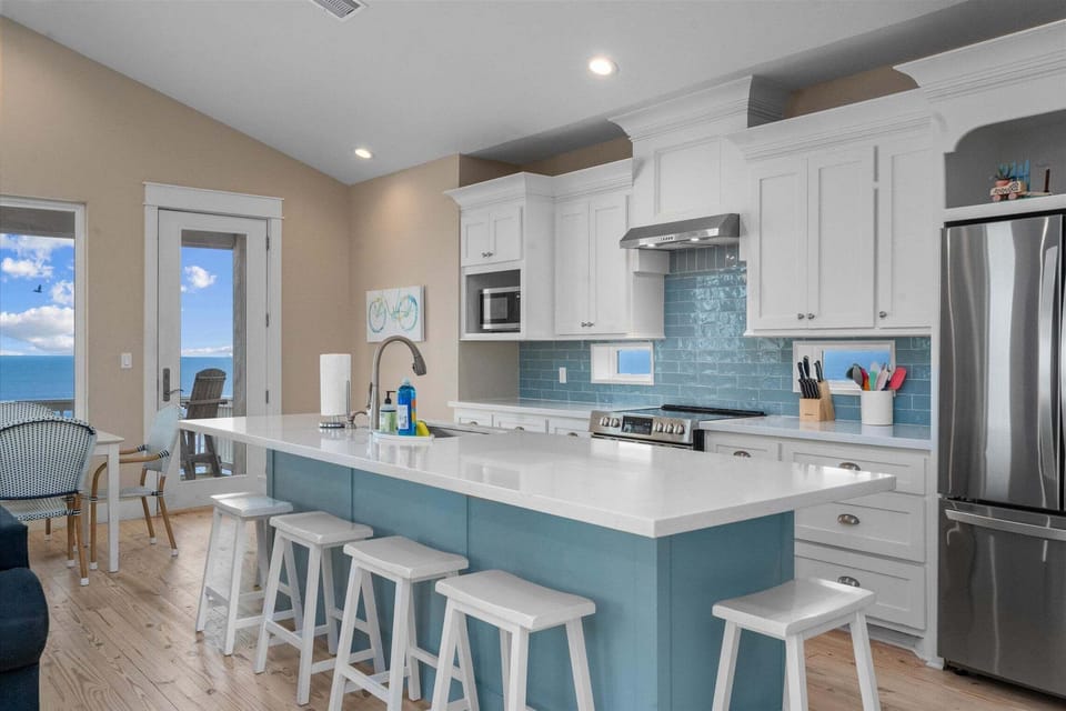 Fully equipped gourmet kitchen with quartz countertops and open layout for entertaining guests.