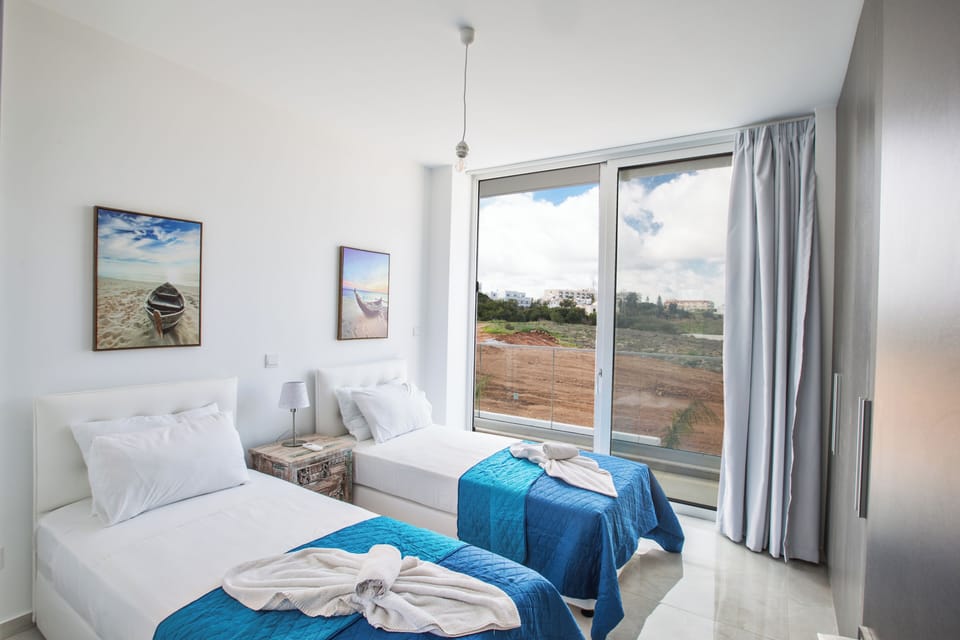 Bedroom 3 with two single beds and balcony